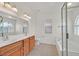 Main bathroom with double vanity, toilet, and glass-enclosed shower at 5517 Meridian Rain St, North Las Vegas, NV 89031