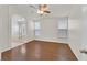 Main bedroom with hardwood floors, ceiling fan, and bathroom entrance at 5517 Meridian Rain St, North Las Vegas, NV 89031