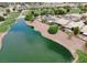 This aerial view captures a property with a private pool, solar panels, and access to a scenic lake at 5845 Swan Point Pl, Las Vegas, NV 89122