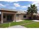 Well-maintained backyard with green grass, mature palm tree, and covered patio, ideal for outdoor living and entertaining at 5845 Swan Point Pl, Las Vegas, NV 89122