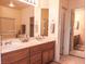 Bathroom features double sinks, framed mirrors, and wood cabinetry at 5845 Swan Point Pl, Las Vegas, NV 89122