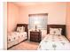 Cozy bedroom with twin beds, palm tree-themed decor, and natural light at 5845 Swan Point Pl, Las Vegas, NV 89122