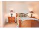Bedroom featuring wooden furniture, soft lighting, and neutral carpeting at 5845 Swan Point Pl, Las Vegas, NV 89122