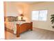 Bedroom with a large window and a wooden bed frame with a floral comforter at 5845 Swan Point Pl, Las Vegas, NV 89122