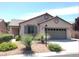 A front elevation of a one-story home with a desert landscaped yard and a two-car garage at 5845 Swan Point Pl, Las Vegas, NV 89122