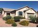 A front elevation of a one-story home with a desert landscaped front yard and a two-car garage at 5845 Swan Point Pl, Las Vegas, NV 89122