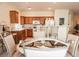 Bright kitchen features wood cabinets and a convenient breakfast bar at 5845 Swan Point Pl, Las Vegas, NV 89122