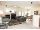 A comfortable living room featuring a fireplace, ceiling fan, and neutral decor, perfect for relaxation at 5845 Swan Point Pl, Las Vegas, NV 89122