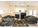 A comfortable living room featuring a fireplace, ceiling fan, and neutral decor, perfect for relaxation at 5845 Swan Point Pl, Las Vegas, NV 89122