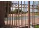 This property boasts a serene water view, offering a tranquil escape and a picturesque backdrop through an iron fence at 5845 Swan Point Pl, Las Vegas, NV 89122