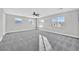 Spacious bedroom with plush gray carpet, a ceiling fan, and plenty of natural light at 600 Baysville Ct, Las Vegas, NV 89144