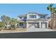 Traditional two-story home showcasing a manicured front lawn and a three-car garage at 600 Baysville Ct, Las Vegas, NV 89144