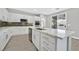 Modern kitchen with white cabinets, an island with marble countertop, and stainless steel appliances at 600 Baysville Ct, Las Vegas, NV 89144