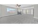 Open-concept living room with a fireplace, neutral color palette, and plush gray carpet at 600 Baysville Ct, Las Vegas, NV 89144