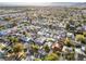 Broad aerial shot displaying the neighborhood's streets, houses, and lush green trees at 620 Avenue H, Boulder City, NV 89005