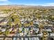 Wide aerial shot captures neighborhood with homes and mature vegetation with a distant mountain range backdrop at 620 Avenue H, Boulder City, NV 89005
