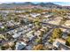Neighborhood aerial view displaying streets, nearby buildings, and mountain views in the distance at 620 Avenue H, Boulder City, NV 89005