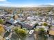 Aerial view shows residential neighborhood and a parked RV in the driveway with nearby mature trees at 620 Avenue H, Boulder City, NV 89005