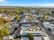 Overhead shot of neighborhood featuring mature trees, well maintained houses, and a view of distant mountains at 620 Avenue H, Boulder City, NV 89005