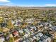 Expansive aerial view shows a quiet neighborhood, with many mature trees, with a mountain range in the distance at 620 Avenue H, Boulder City, NV 89005