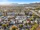 Expansive aerial view of neighborhood with tree-lined streets, and a scenic mountain backdrop at 620 Avenue H, Boulder City, NV 89005
