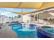 Inviting backyard pool and spa area with a shade sail and ample space for relaxation at 620 Avenue H, Boulder City, NV 89005