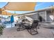 Outdoor patio with a fire pit, seating, a shade sail, and a view of the pool and backyard at 620 Avenue H, Boulder City, NV 89005