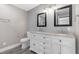 Bathroom featuring double sink vanity, granite countertop, and modern fixtures at 620 Avenue H, Boulder City, NV 89005