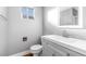 Bathroom with simple vanity, toilet and small window at 620 Avenue H, Boulder City, NV 89005