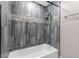 Sleek bathtub and shower combination with elegant marble tiling and fixtures at 620 Avenue H, Boulder City, NV 89005