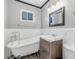 Bathroom features vintage tub, modern vanity, and sleek white paneling at 620 Avenue H, Boulder City, NV 89005