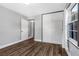 Bright bedroom with hardwood floors, a built-in wardrobe, and a window for natural light at 620 Avenue H, Boulder City, NV 89005