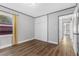 Simple bedroom featuring hardwood floors, neutral walls, and a built-in closet for storage at 620 Avenue H, Boulder City, NV 89005