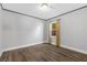 Clean bedroom with hardwood floors, neutral walls, and a window with sheer curtains at 620 Avenue H, Boulder City, NV 89005