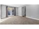 Cozy bedroom featuring plush carpeting, a glass door leading to the outside, and neutral walls at 620 Avenue H, Boulder City, NV 89005