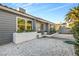 Close up view of a gray-sided single story home with a tile roof and white rock landscaping at 620 Avenue H, Boulder City, NV 89005