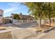 Charming single-story home with a well-manicured lawn, mature trees, and a welcoming white picket fence at 620 Avenue H, Boulder City, NV 89005