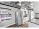 Updated kitchen with stainless steel appliances, white cabinets, and decorative window coverings at 620 Avenue H, Boulder City, NV 89005