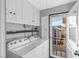 Bright laundry room equipped with washer, dryer, and ample storage cabinets at 620 Avenue H, Boulder City, NV 89005