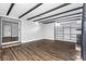 Spacious living room featuring hardwood floors, decorative ceiling beams, and a custom shelving unit at 620 Avenue H, Boulder City, NV 89005