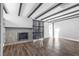 Bright living room with hardwood floors, a fireplace, beamed ceilings and barn doors at 620 Avenue H, Boulder City, NV 89005
