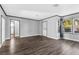 Spacious living room with dark wood floors, a front door, and access to other rooms at 620 Avenue H, Boulder City, NV 89005