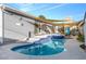 Backyard pool and spa with elegant tile accents and shade sails providing a tranquil and shaded retreat at 620 Avenue H, Boulder City, NV 89005