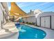 Beautiful backyard pool and spa with custom decking and shade sails, creating a private outdoor oasis at 620 Avenue H, Boulder City, NV 89005