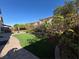 Tranquil backyard featuring a patio, artificial turf, and mature trees for privacy at 6277 Mustang Spring Ave, Las Vegas, NV 89139