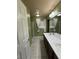 Bathroom with double sinks, walk-in shower, and ample lighting at 6277 Mustang Spring Ave, Las Vegas, NV 89139