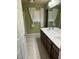 Bathroom featuring dual sinks, a large mirror, and a window with curtains for privacy at 6277 Mustang Spring Ave, Las Vegas, NV 89139