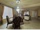 Formal dining room showcasing chandelier, table, and entry to living room at 6277 Mustang Spring Ave, Las Vegas, NV 89139