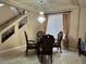 Dining area featuring a modern chandelier and a glass-top table with seating for four at 6277 Mustang Spring Ave, Las Vegas, NV 89139