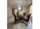 Formal dining room with a decorative chandelier and glass-top table at 6277 Mustang Spring Ave, Las Vegas, NV 89139